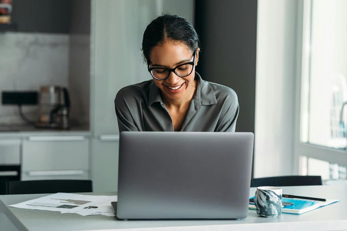 Female business owner looking at her website designed by The Pridham Group
